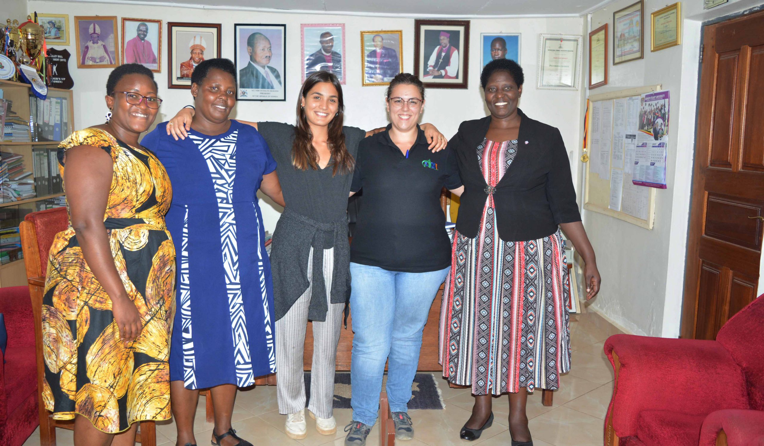 The AVSI team posing for a photo in the University Vice Chancellor's office with the Prof. Maud Kamatenesi Mugisha (PhD)
