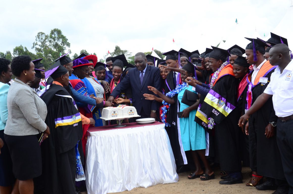 HESFB Team and students funded by HESFB cutting cake at 15th BSU Graduation