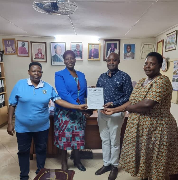 L-R: The University Secretary, Ms. Assiimwe Annah Tibazindwa, VC - Prof. Maud Kamatenesi Mugisha, Mr. Ben K. Twine and Deborah Akatwetaba show off the signed MoU - 25th May 2022