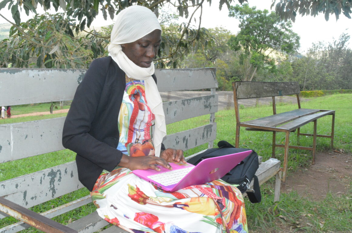 A female student with a laptop near the Department of Computing Library and Information Technology, behind Lab C, BSU on 3rd May 2022