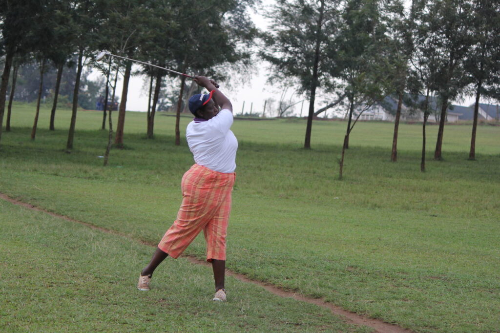 The VC, Prof. Maud Kamatenesi Mugisha swings at the golf ball after the launch of Golf Game at BSU_ during the 4th BSU Week _Feb 2018