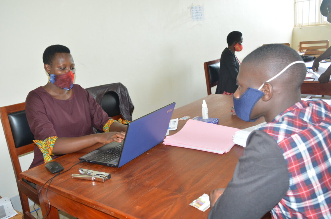 A male fresh student (August Intake AY 2021/22 ) being registered by the Assistant Registrar, Mrs. Nsiime Viola on 21st October 2021, Business Block, Level 1, Main Campus, Mbarara, Uganda