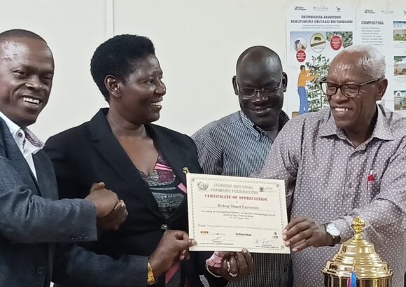 The Chairman LCV Mbarara District, Mr. Tabaro Didas (L), Prof. Maud Kamatenesi Mugisha (2nd-L) and Prof. Kenneth Kagame (R) show a certificate of appreciation presented to BSU
