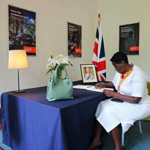 Prof. Maud Kamatenesi Mugisha signing a condolence book for Her Majesty the Queen, Elizabeth II