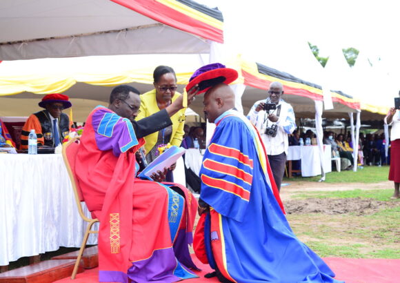 The Chancellor, Rt. Rev. Fred Sheldon Mwesigwa (PhD) - Assoc. Prof. of Religious Education, confers a Doctor of Philosophy upon Dr. Chrispo Maali during the 18th Graduation _ 24 _March _2023