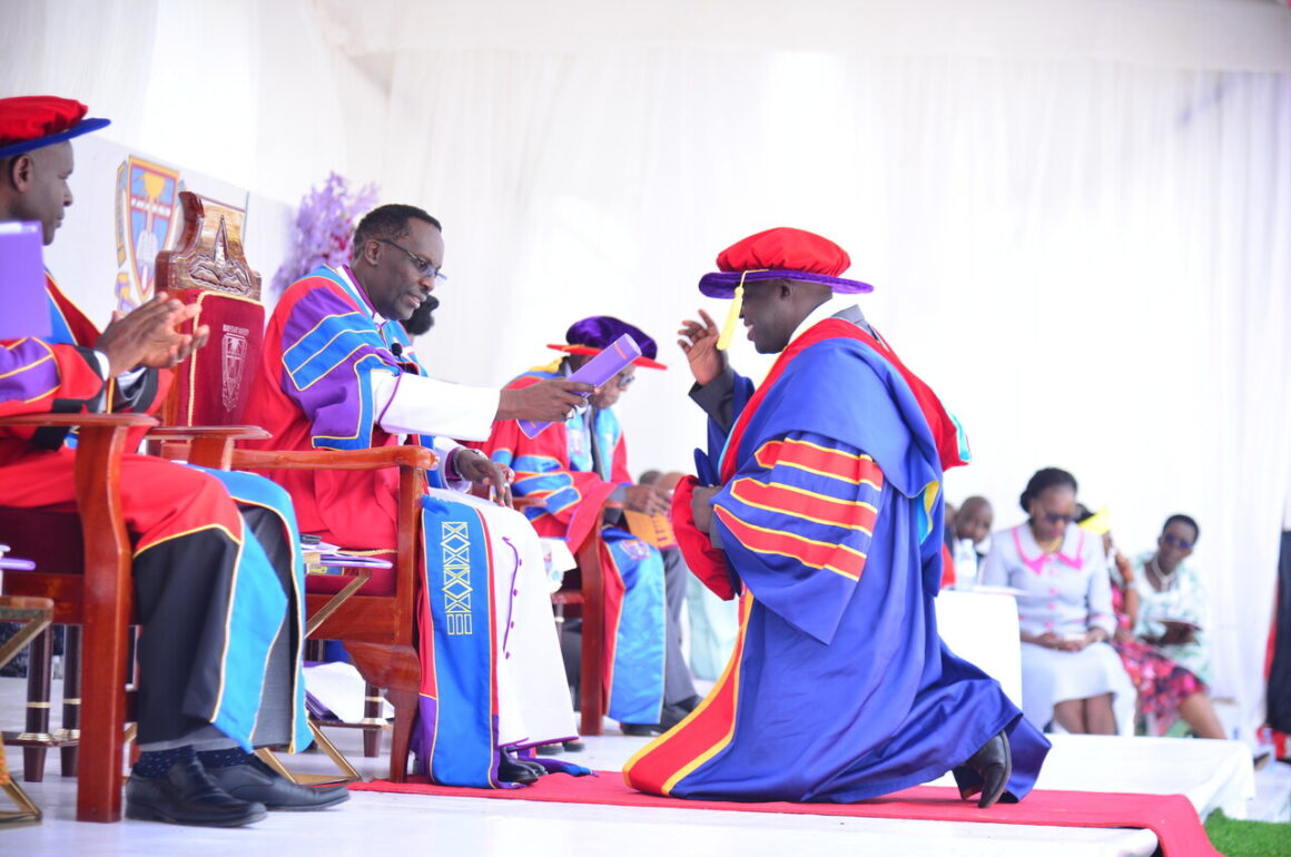 Assoc. Prof. Fred Sheldon Mwesigwa (Chancellor) confers Degree of Doctor of Philosophy in Language, Culture and Society upon Mr. Balituumye Michael (R) during 20th Congregation of BSU Oct. 2024